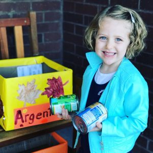 SSH preschool student donates canned goods, learning through community service projects.