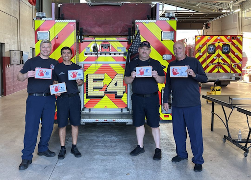 Firefighters receive hand-made thank you cards from preschoolers at Spanish Schoolhouse